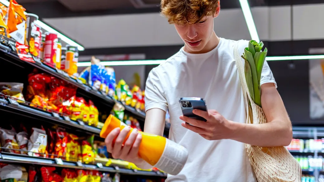 Teen scanning a juice drink in a grocery convenience store