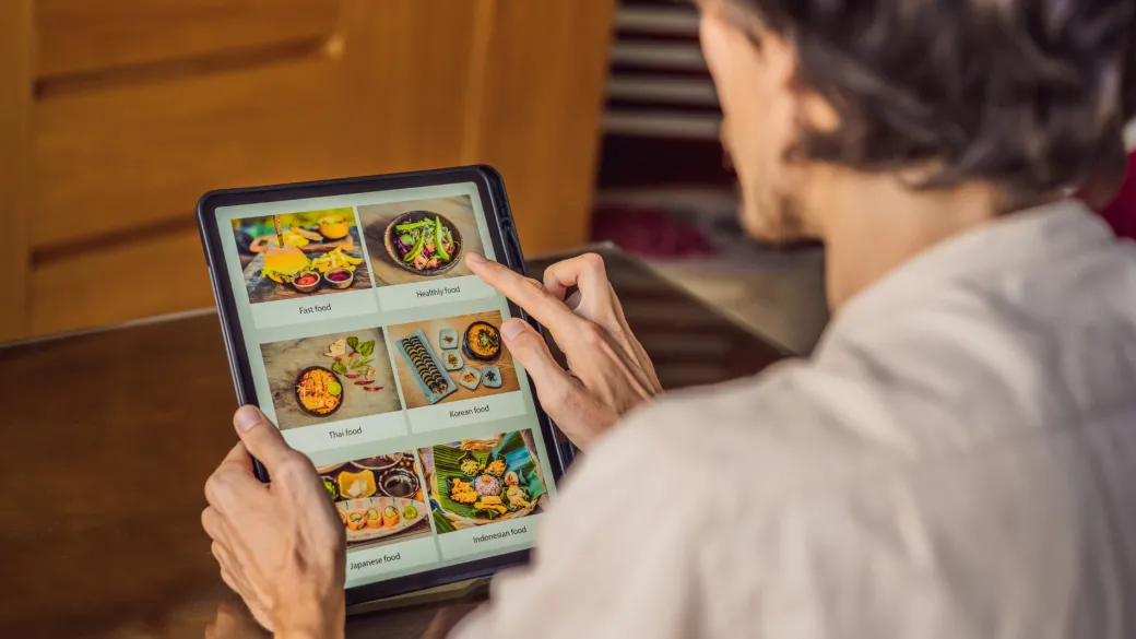 detail online ordering man orders food lunch online using tablet