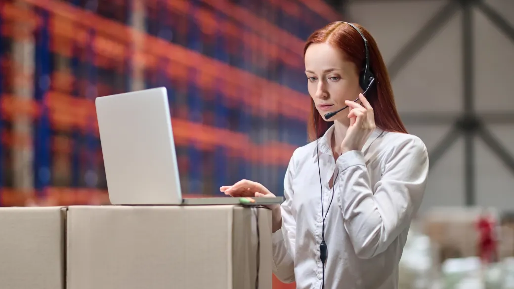 people self services onboarding woman headset standing near laptop warehouse