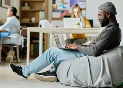 Man comfortable in a chair with laptop