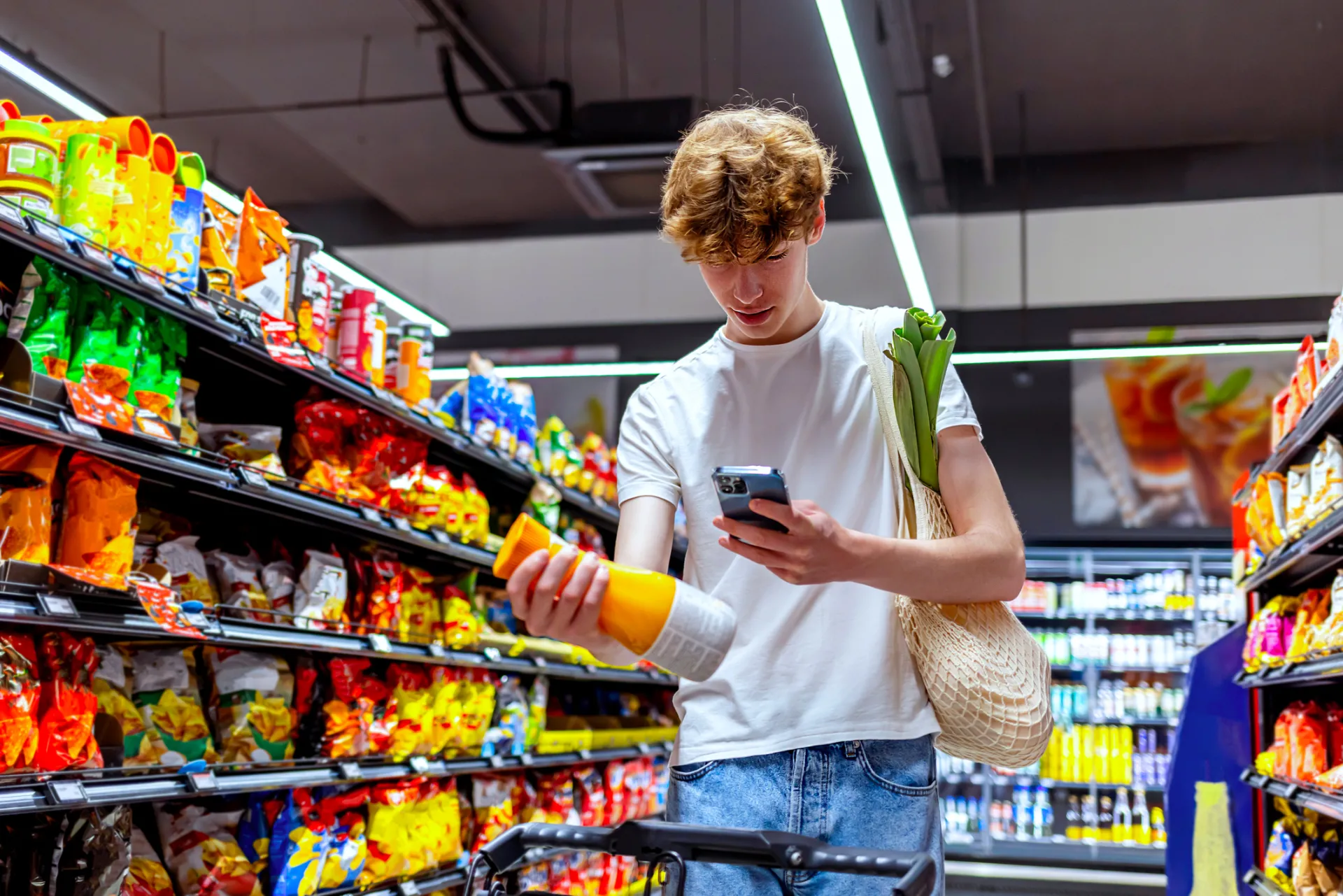 young man scanning a juice bottle in  convenience store
