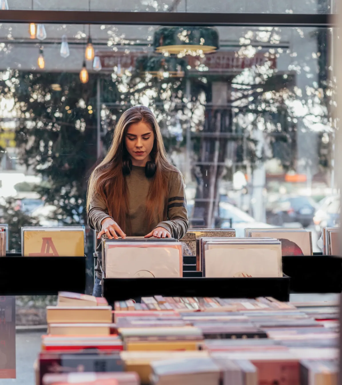 people in person payments woman choosing vinyl record music