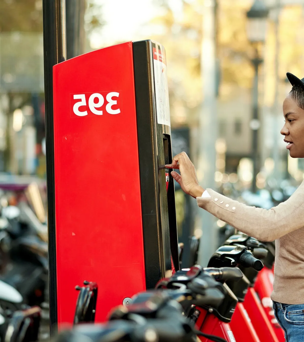 woman at kiosk paying for bike rental
