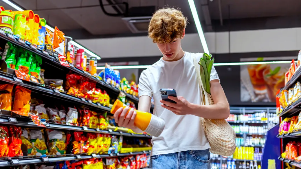 young man scanning a juice bottle in  convenience store